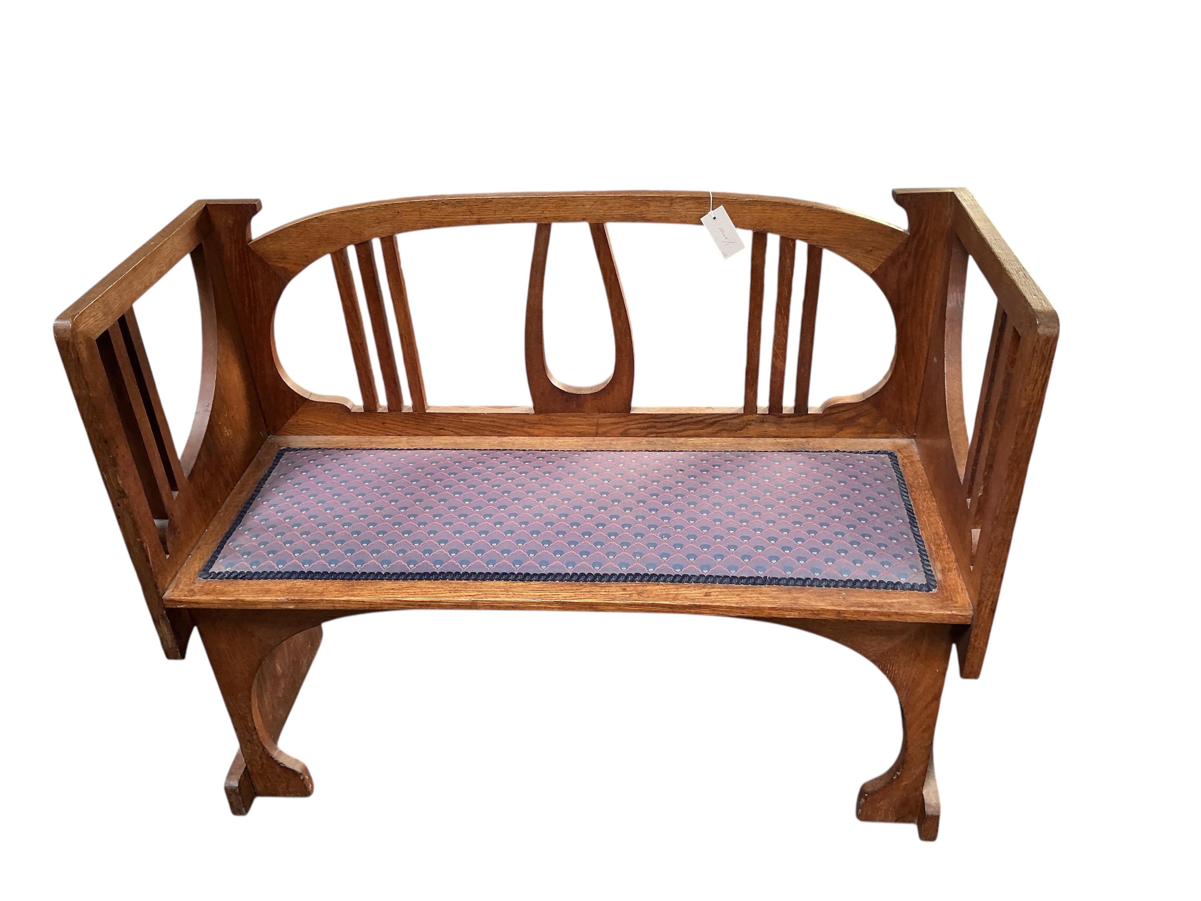 In the manner of Josef Hoffmann, an Art Nouveau oak chair-back settee and similar stool, settee width 110cm, depth 43cm, height 87cm.